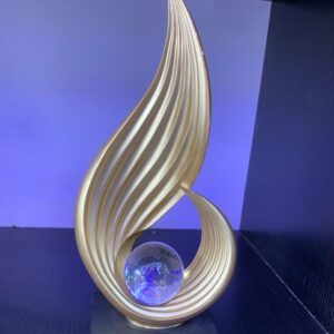Gold wave sculpture with crystal globe