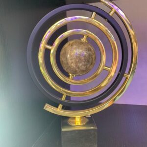 Decorative centerpiece with gold rings and marble-like sphere